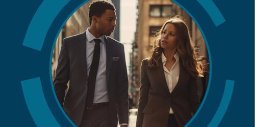 Two legal professionals walk down a city street