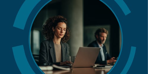 Two legal professionals work on their laptops