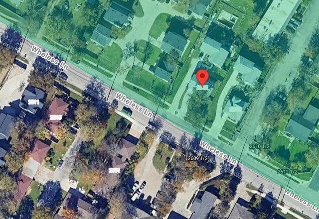 Satellite view of Wheless Lane in Austin with the pin on 2602 Wheless Ln and the Justice Precinct 1 jurisdiction shaded on the north side of the street