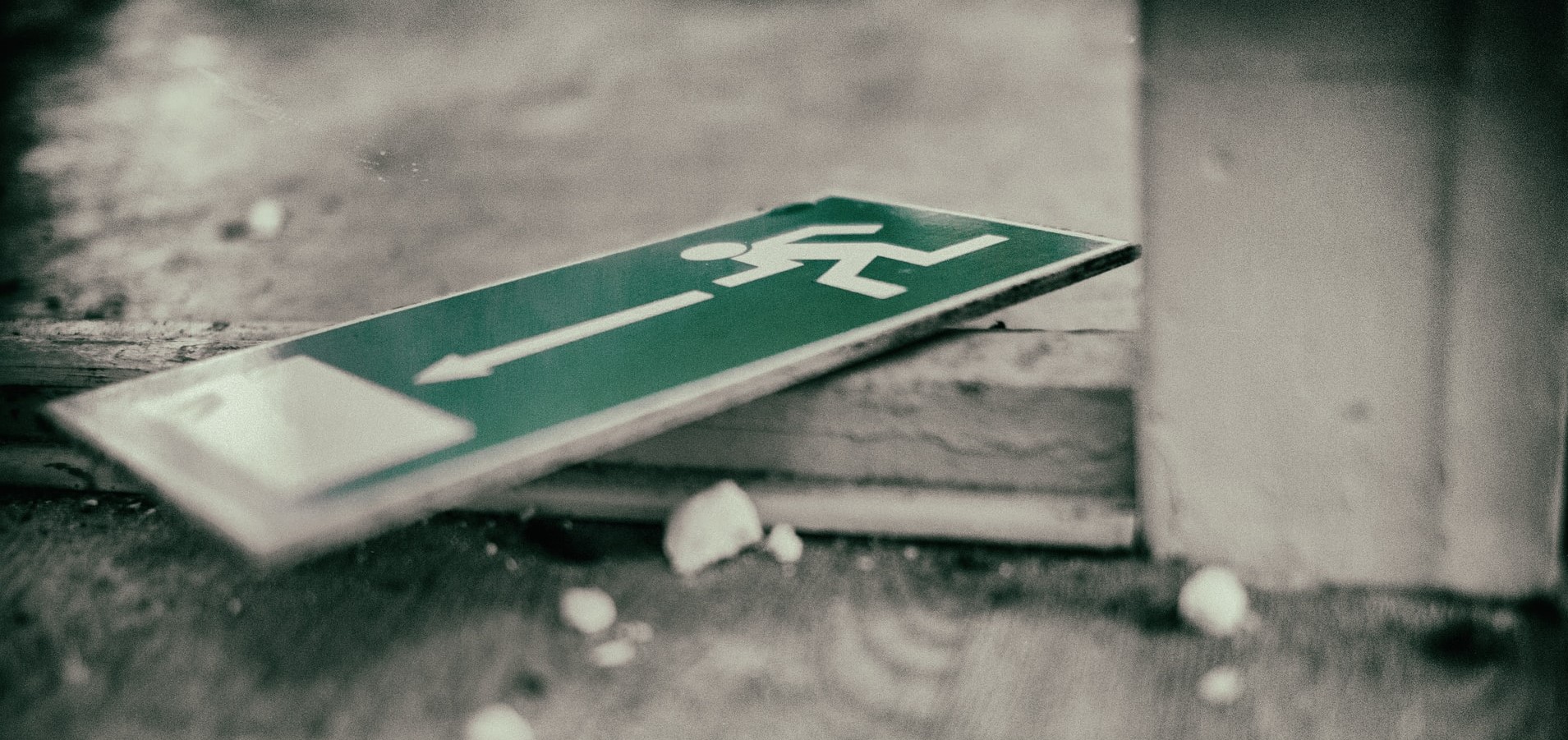 law firm disaster preparedness picture: exit sign lying on floor amid a small amount of debris