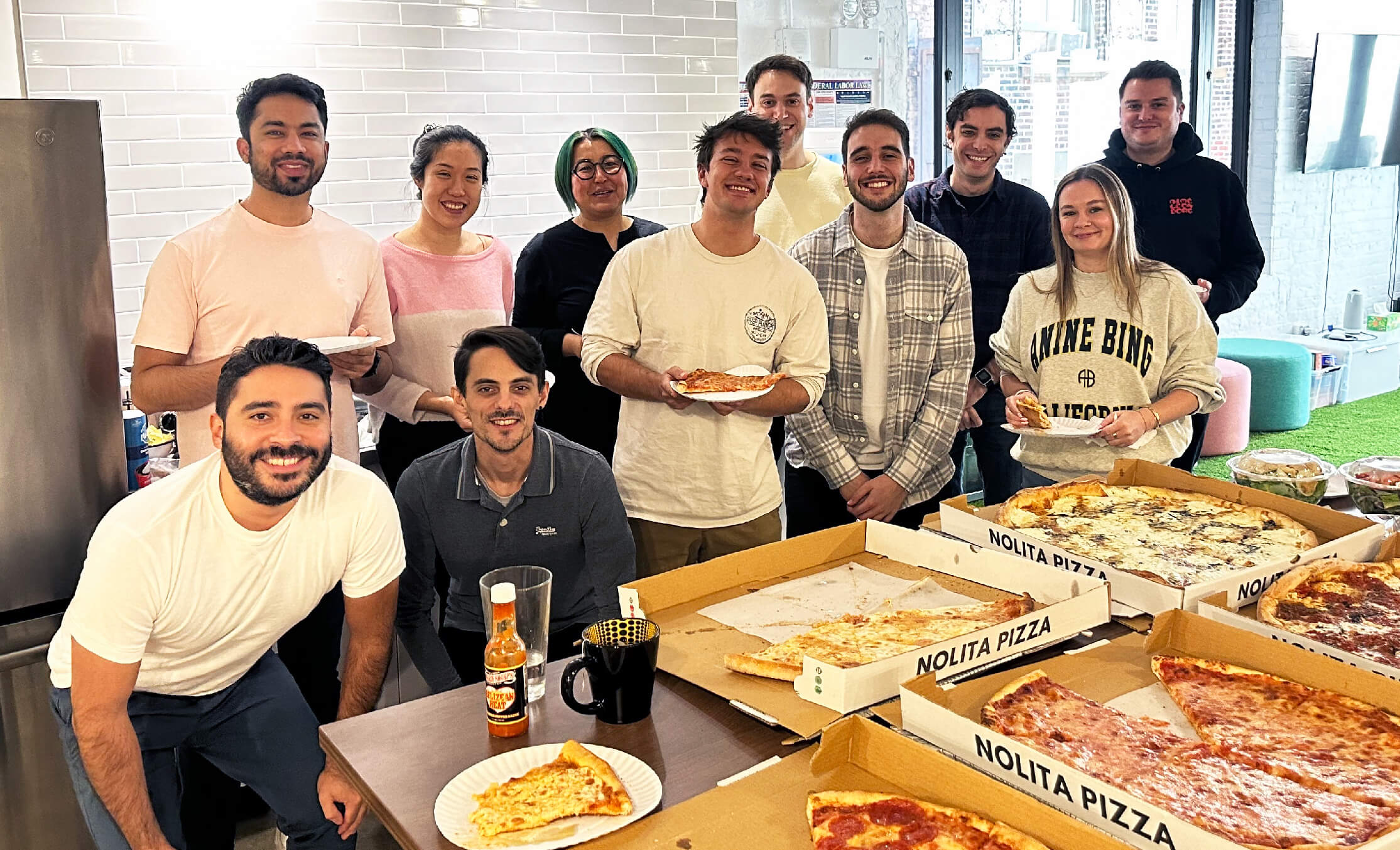 A photo of teammates enjoying pizza